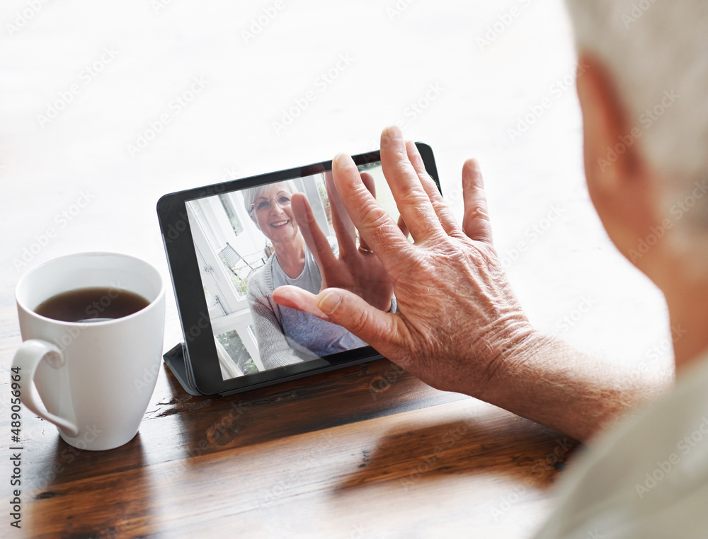 With new technology, were never far apart.... A senior woman having a video chat with her husband on