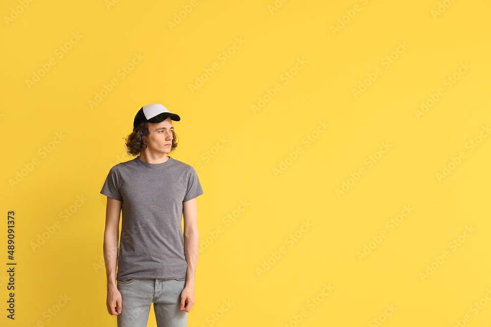 Fashionable young man on color background