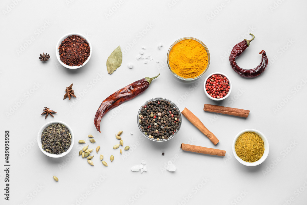 Bowls with aromatic spices on white background