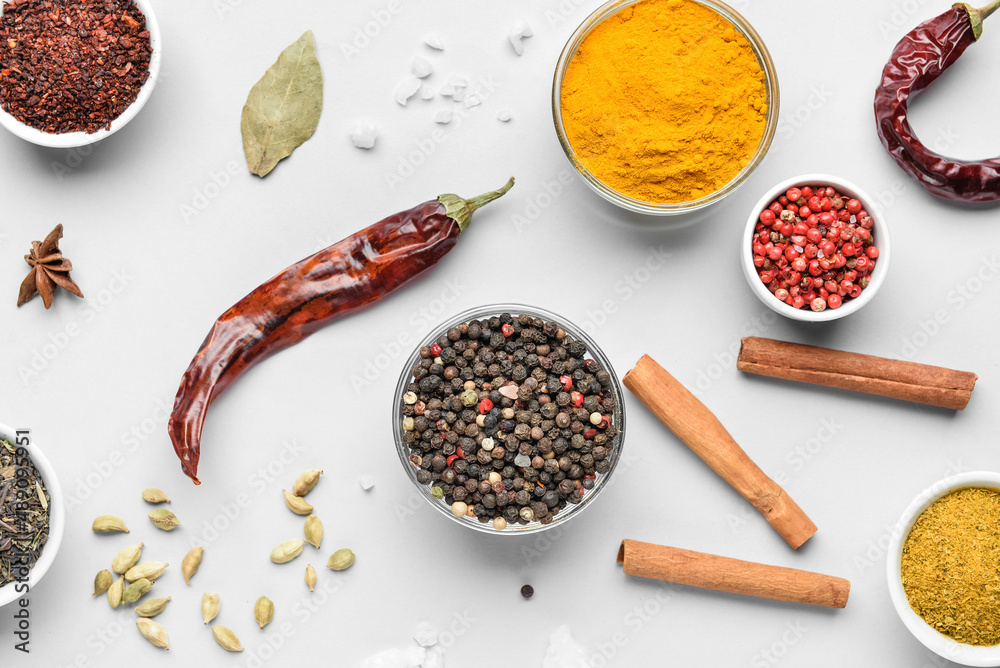 Bowls with aromatic spices on white background