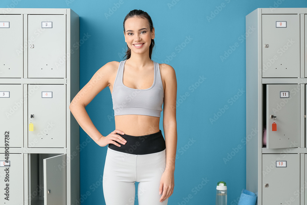 Sporty young woman in locker-room