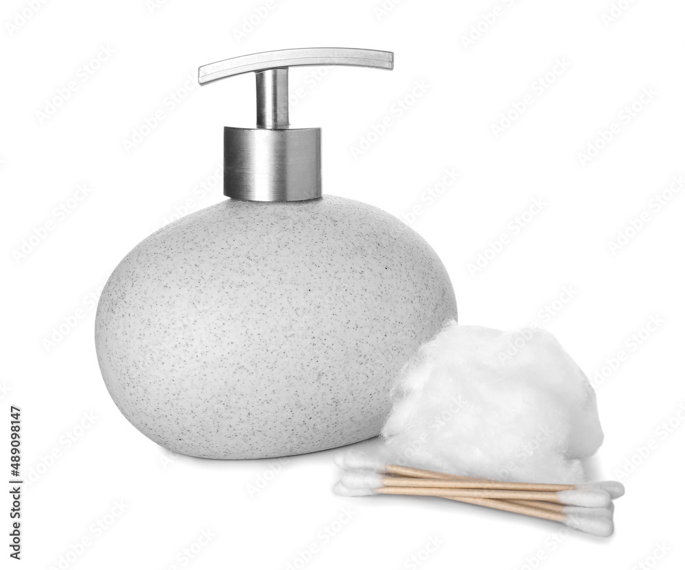 Bottle of cosmetic product, cotton wool and swabs on white background