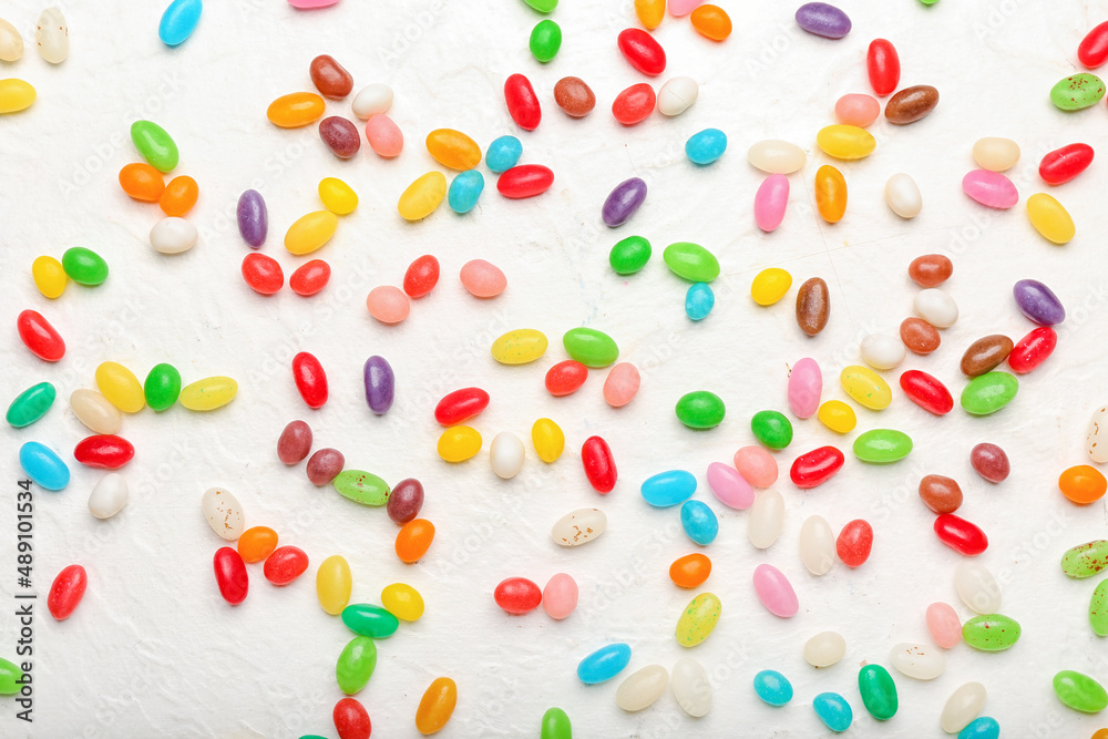 Different jelly beans on white background