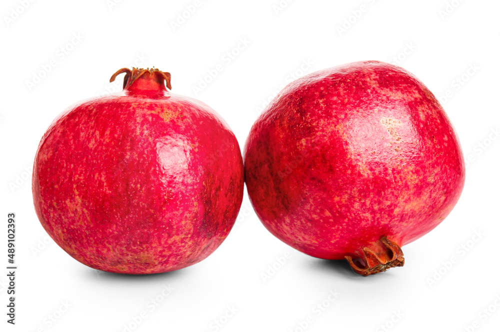 Tasty ripe pomegranates on white background