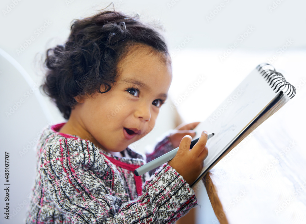 Learning as she grows. Shot of a cute little girl at home.