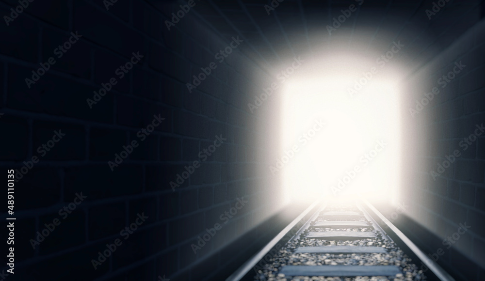 Out of the darkness and into the light. A shot of train tracks coming out of a dark tunnel.