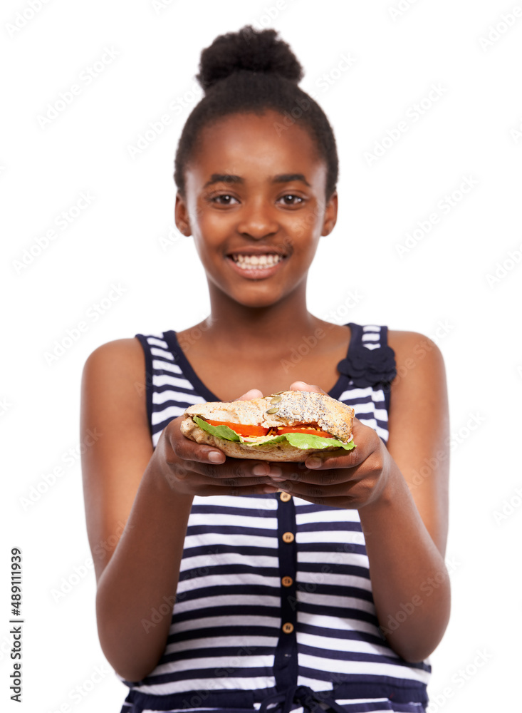 Want to share half. Portrait of a happy young african american girl holding a salad sandwich isolate