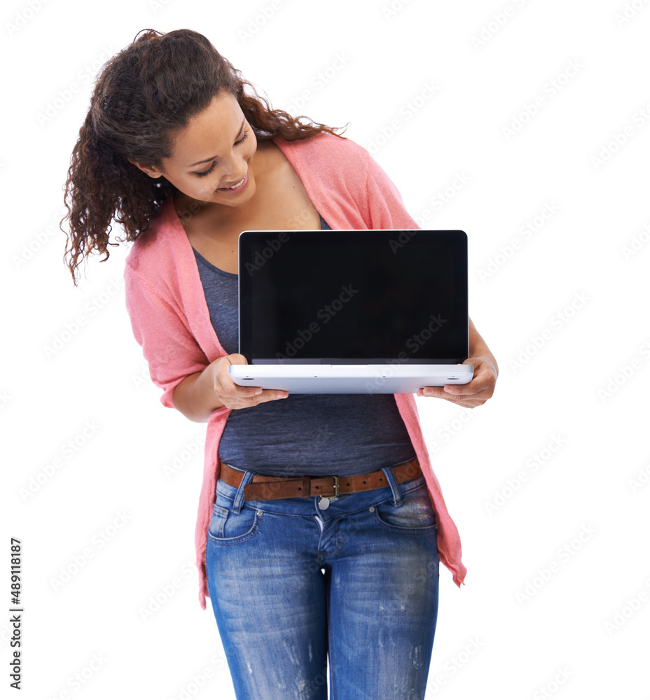 Putting it on display. A beautiful young woman looking at a laptop she is holding and smiling agains