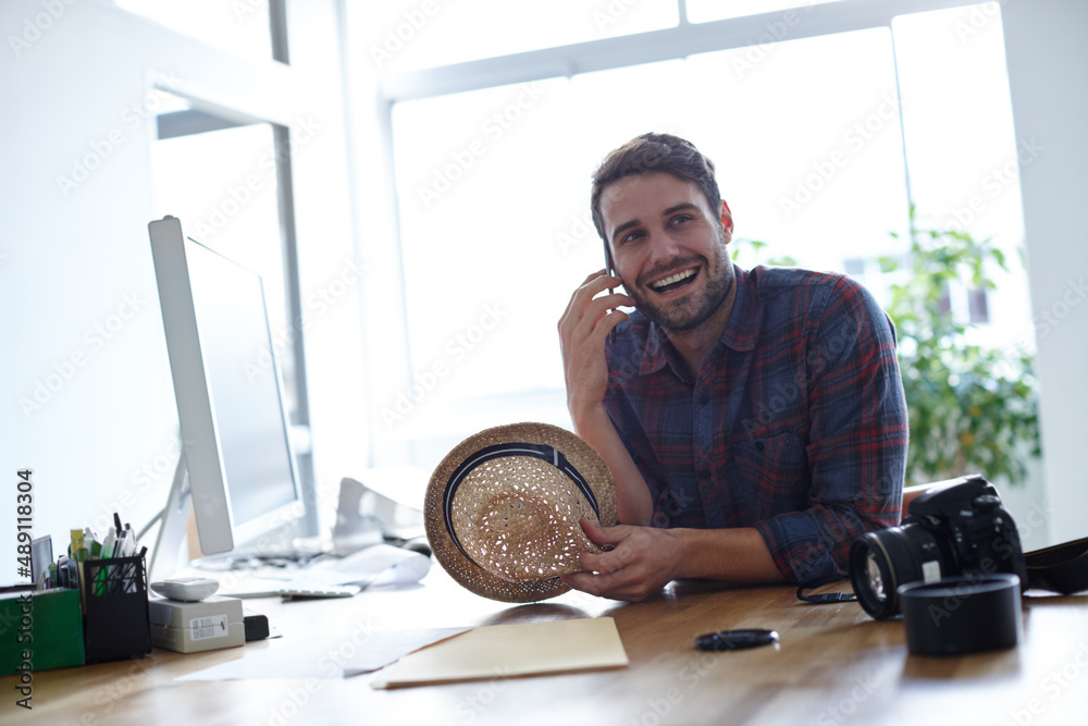 Making my creativity work for me. Shot of a creative professional at his desk talking on his phone.