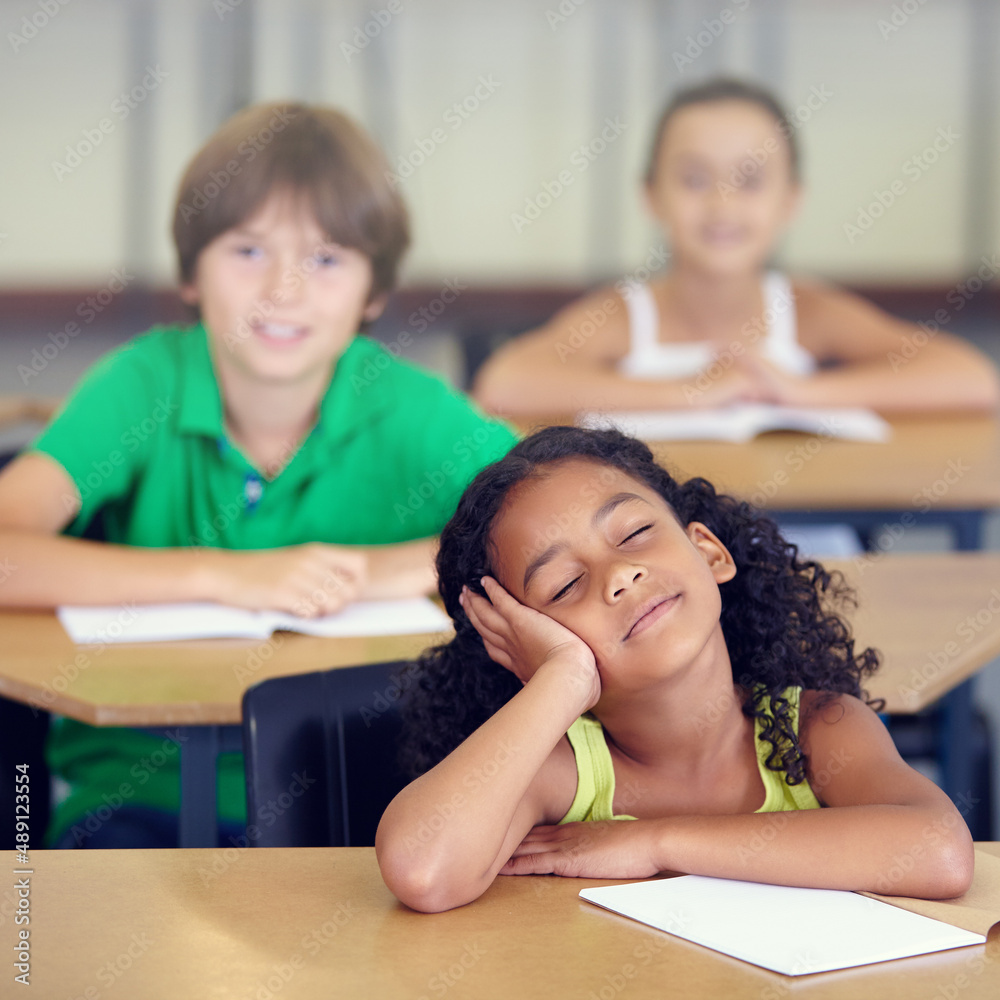 Her minds in another place entirely. A little girl daydreaming during a school lesson.