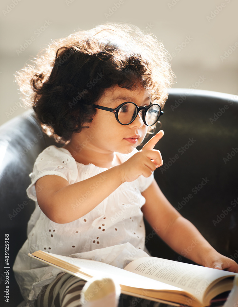 Learning as she grows. Shot of a cute little girl at home.