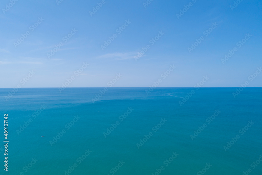 Aerial view of a blue sea surface water texture background and sun reflections Aerial flying drone v