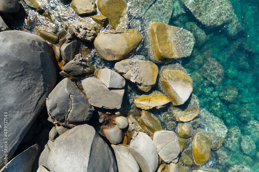 Aerial view Top down seashore rocks sea surface in sunny day Good weather day summer background