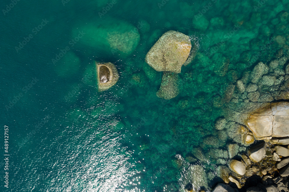 Aerial view Top down seashore rocks sea surface in sunny day Good weather day summer background