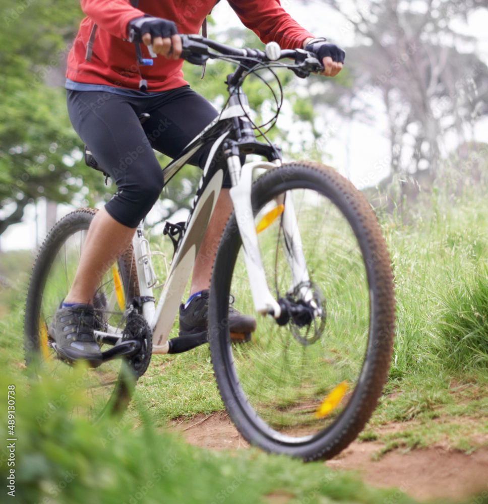 Boys and their toys. A cropped shot of a cyclist riding a trail.