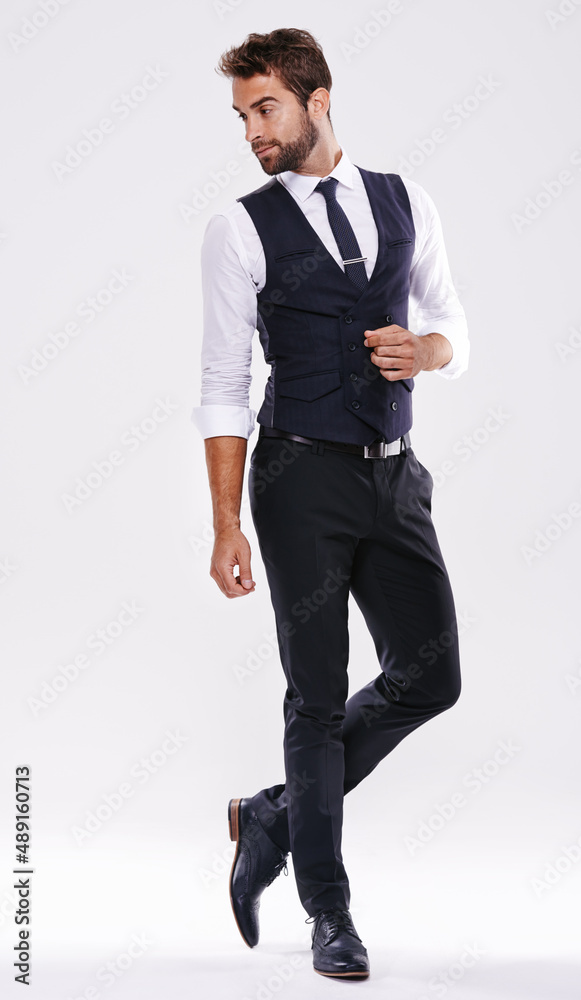 Handsome and successful. Studio shot of a well-dressed man against a gray background.