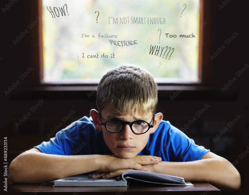 Struggling to learn - Learning disabilities. Young boy feeling overcome with boredom in the classroo