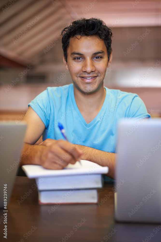 Finals No problem. Portrait of a handsome young student studying for his exams.