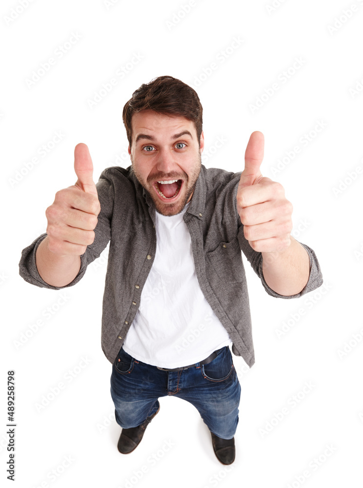 Youre doing great. High-angle shot of a happy young man in studio showing two thumbs up.