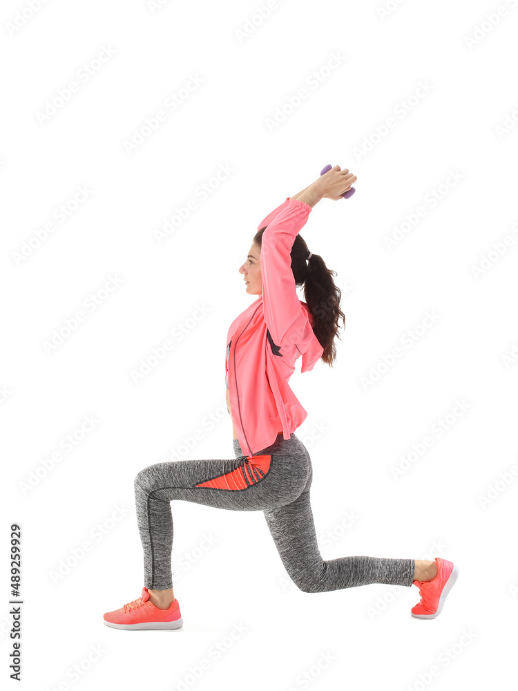 Young sporty woman training with dumbbells on white background