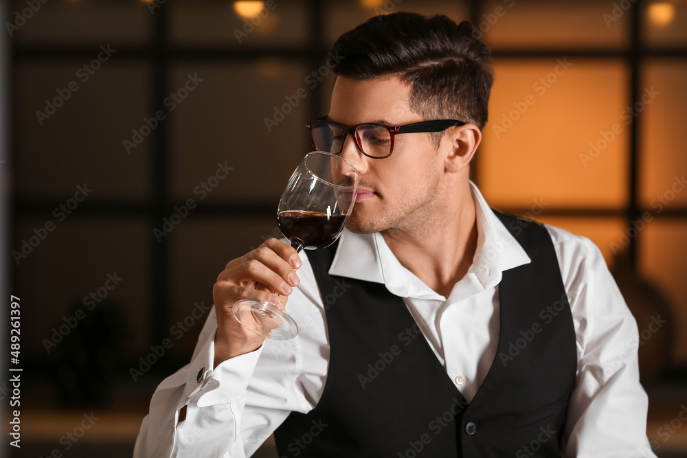 Young male sommelier tasting types of wine