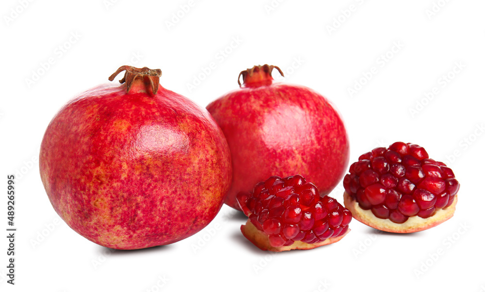 Tasty ripe pomegranates on white background