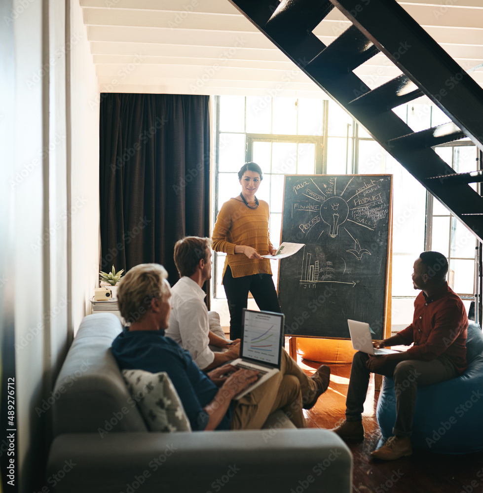 Working through their grand plan. Shot of a businesswoman giving a presentation to her colleagues in