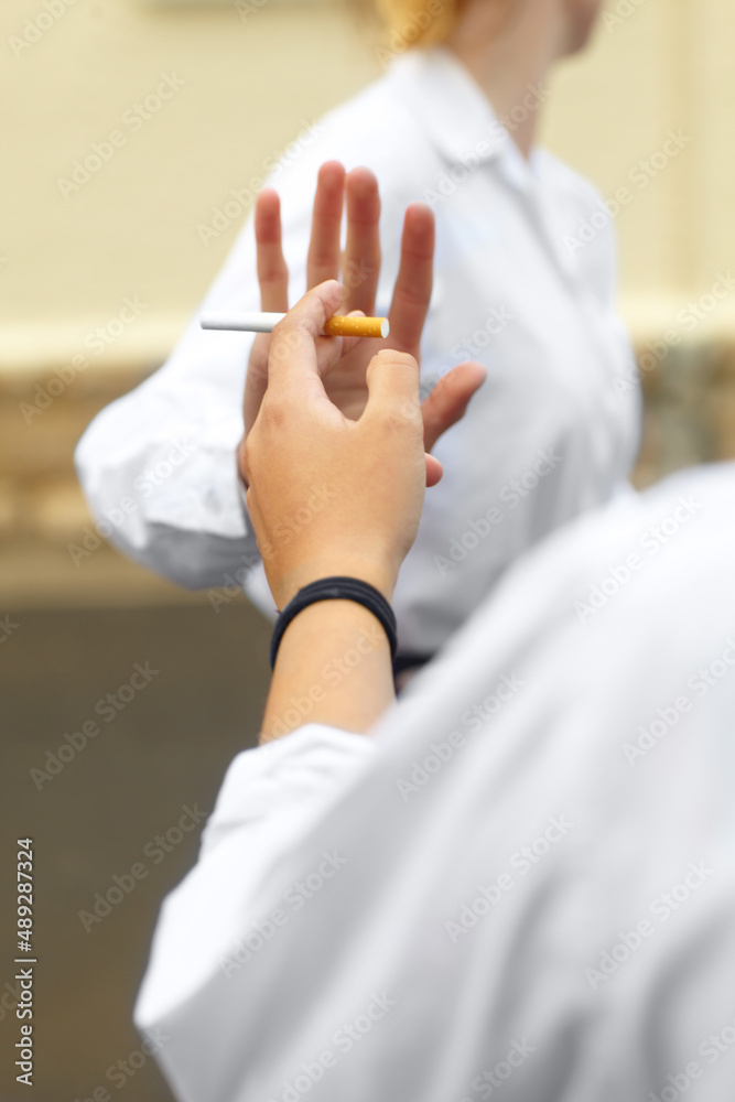 Saying no. Cropped shot of a young female studentd turning down cigarettes in response to peer press