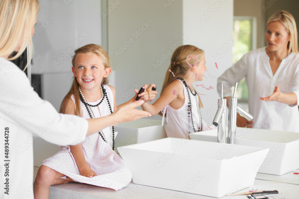 Why did you do this. Little girl in the bathroom in trouble for drawing on the mirror.