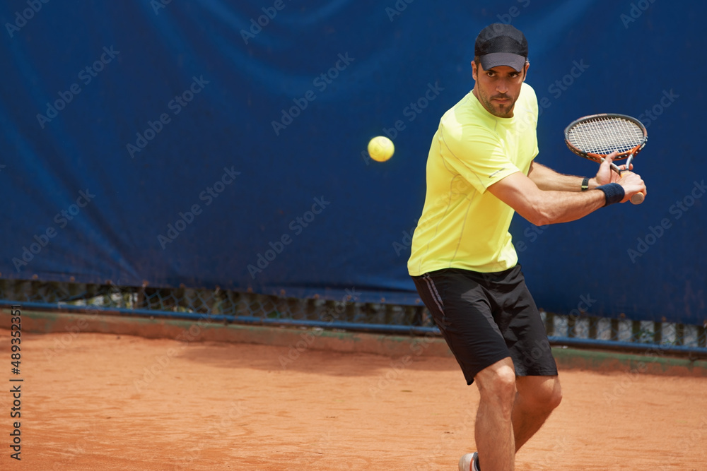 Hes king of the clay. A male tennis player on a clay court.