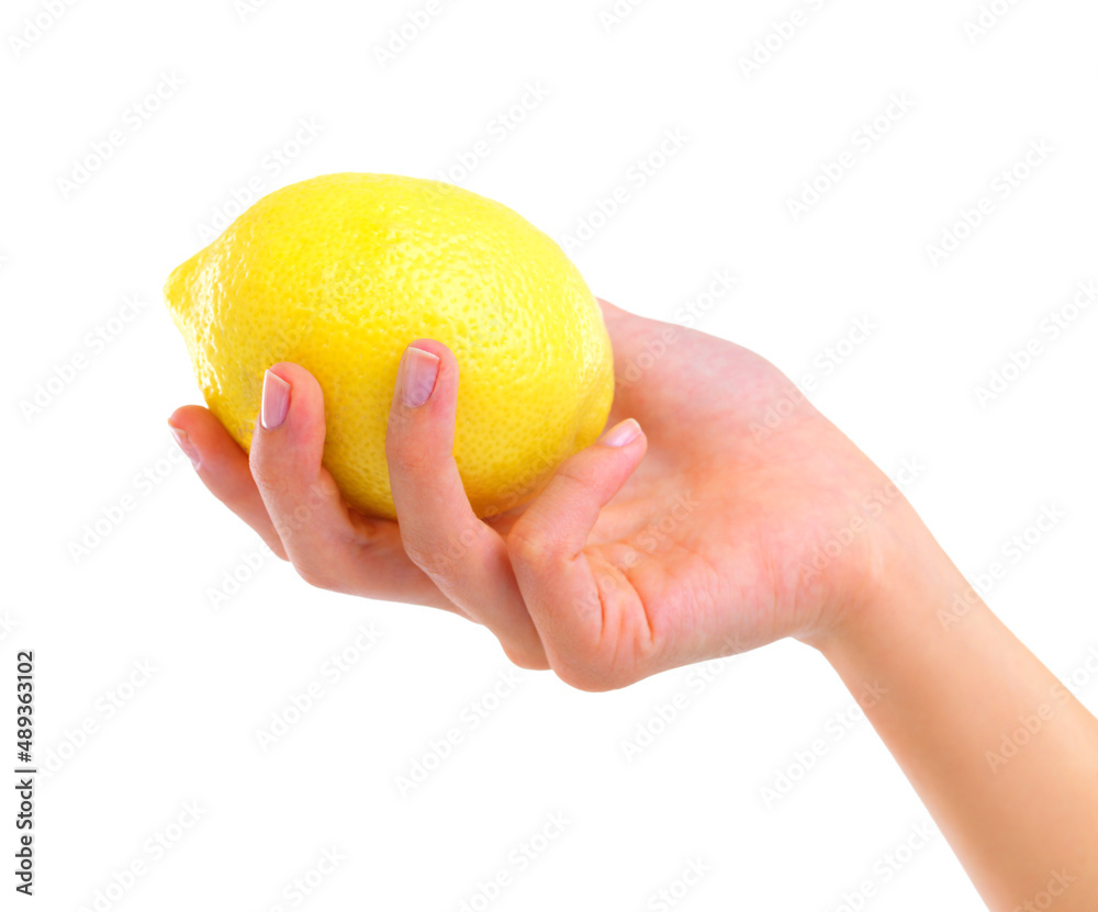 Tangy and delicious. Closeup studio shot of a woman holding a lemon isolated on white.