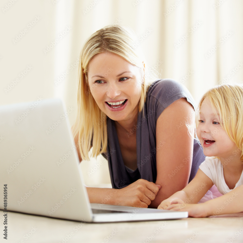 She loves watching cartoons online. Shot of a mother and daughter bonding while surfing the internet