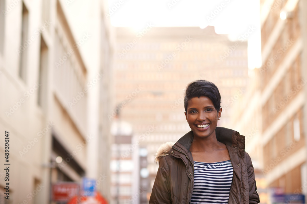 Life in the city is a daily adventure. A cropped portrait of a beautiful young woman in the city.