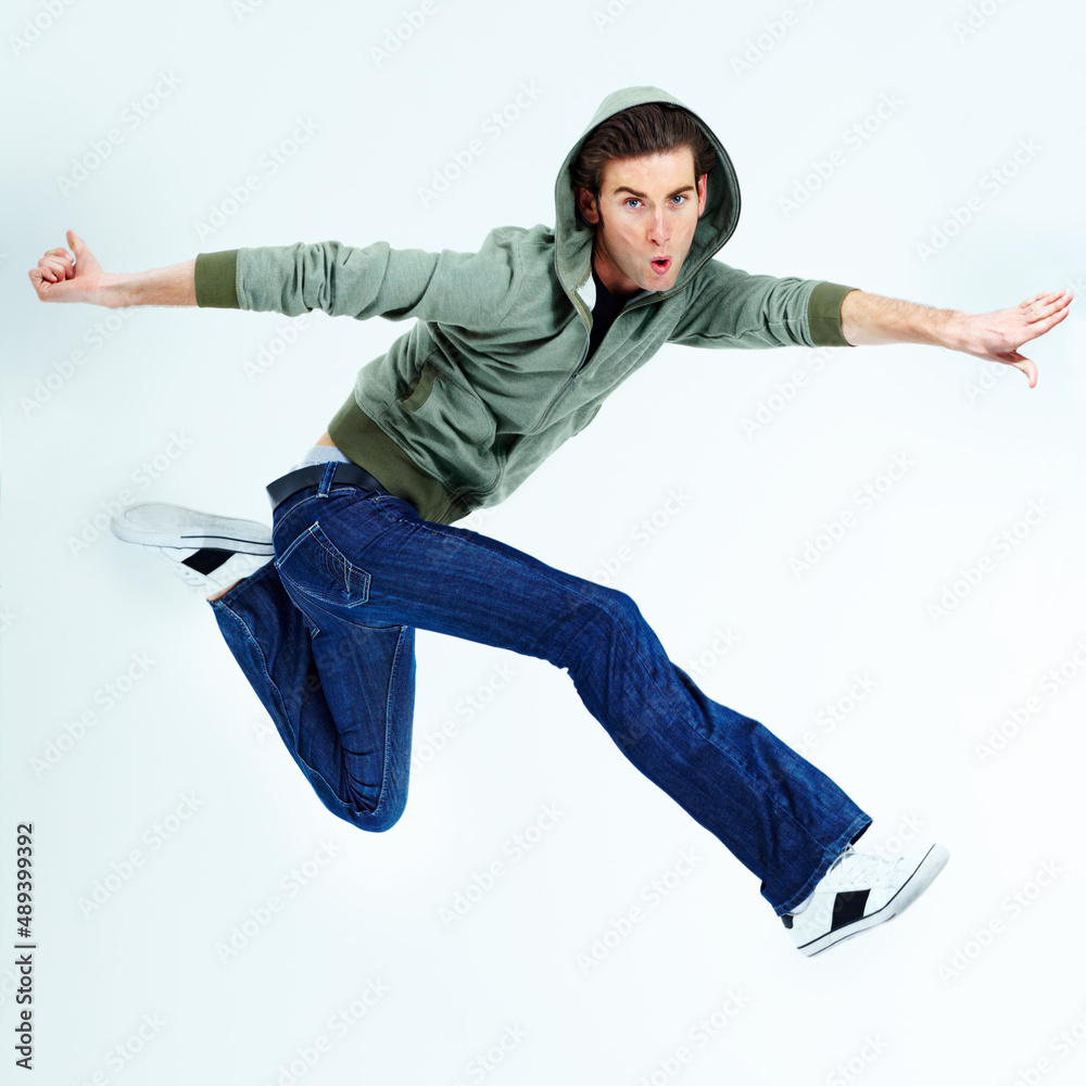 Free and fun-loving in the air. Portrait of a young man posing while jumping in the air.