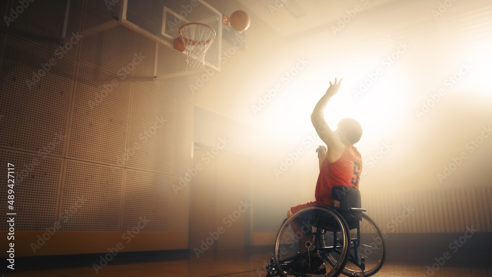 Wheelchair Basketball Player Wearing Red Uniform Shooting Ball Successfully, Scoring a Perfect Goal.