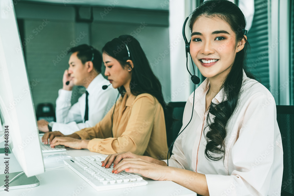 Business people wearing headset working actively in office . Call center, telemarketing, customer su