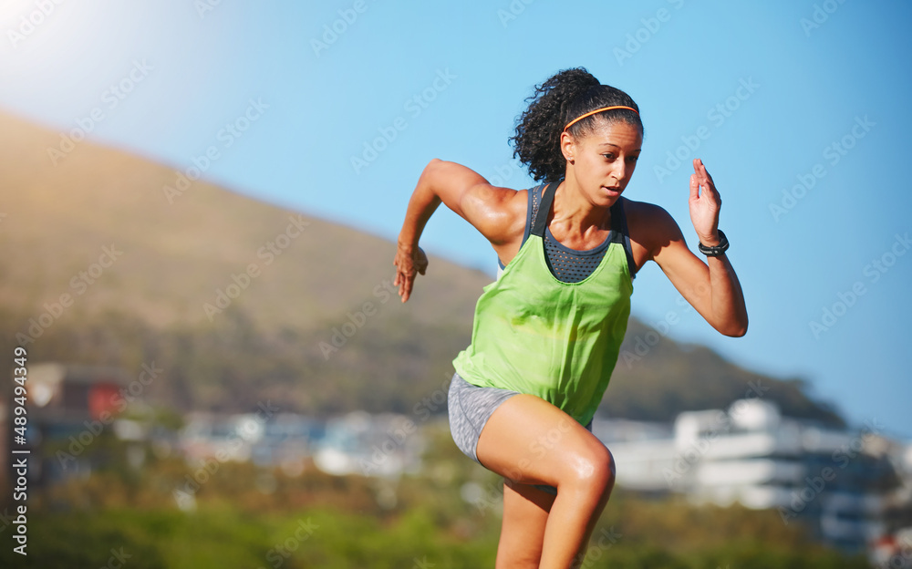 Zooming off towards her fitness goals. Shot of a sporty young woman exercising outdoors.