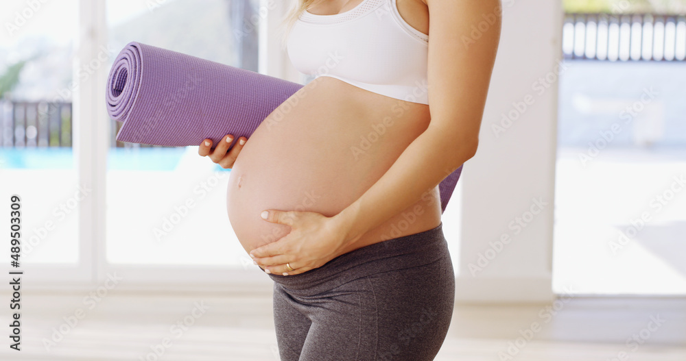 They told me yoga was good for the baby. Cropped shot of an unrecognizable young pregnant woman carr