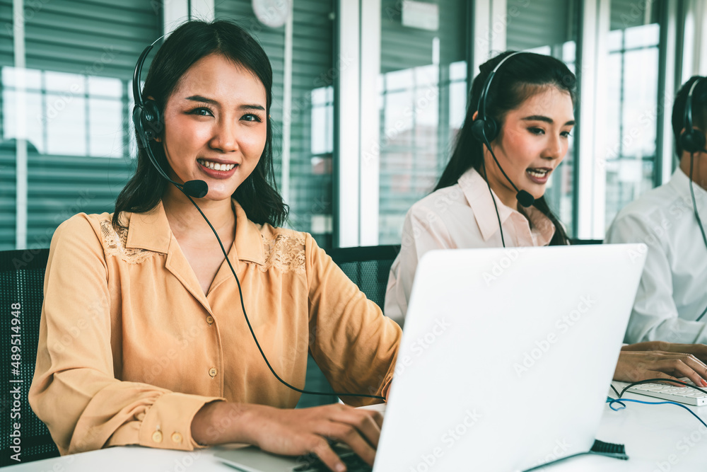 Business people wearing headset working actively in office . Call center, telemarketing, customer su