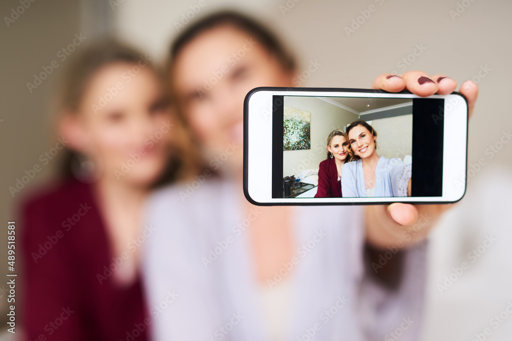 Wedding morning vibes. Cropped shot of a beautiful young bride and her best friend taking a selfie t