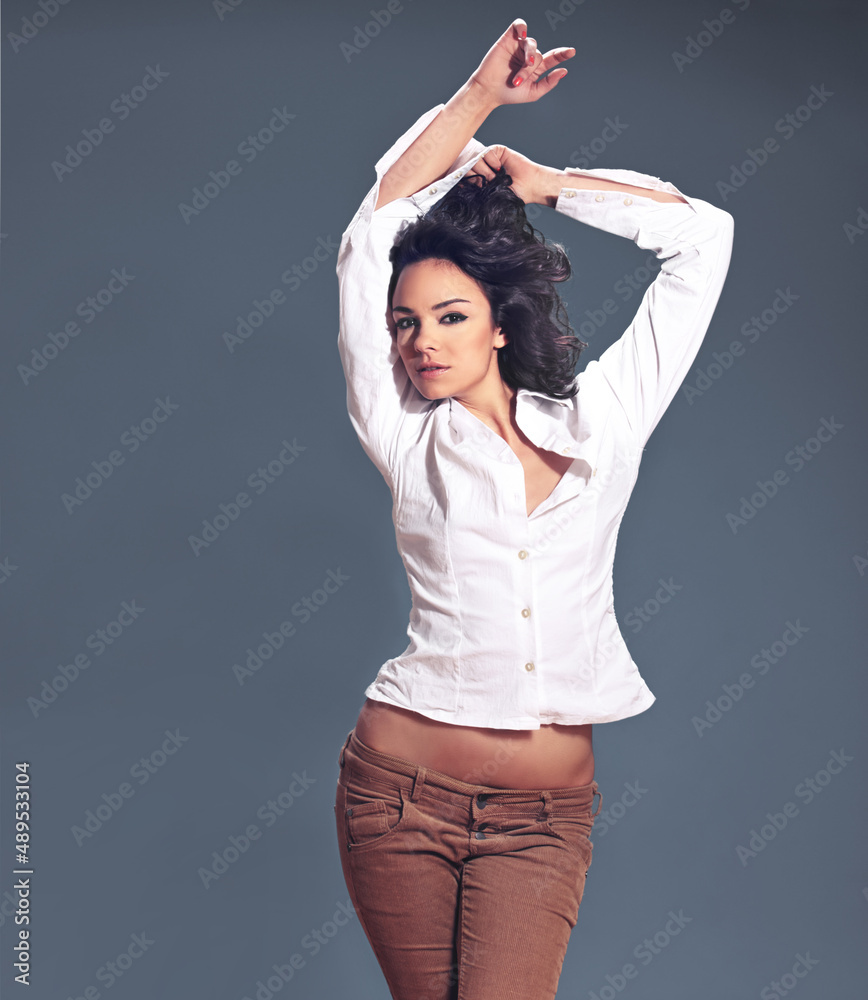 Modeling your clothes with confidence. Studio portrait of a fashionable young woman posing against a