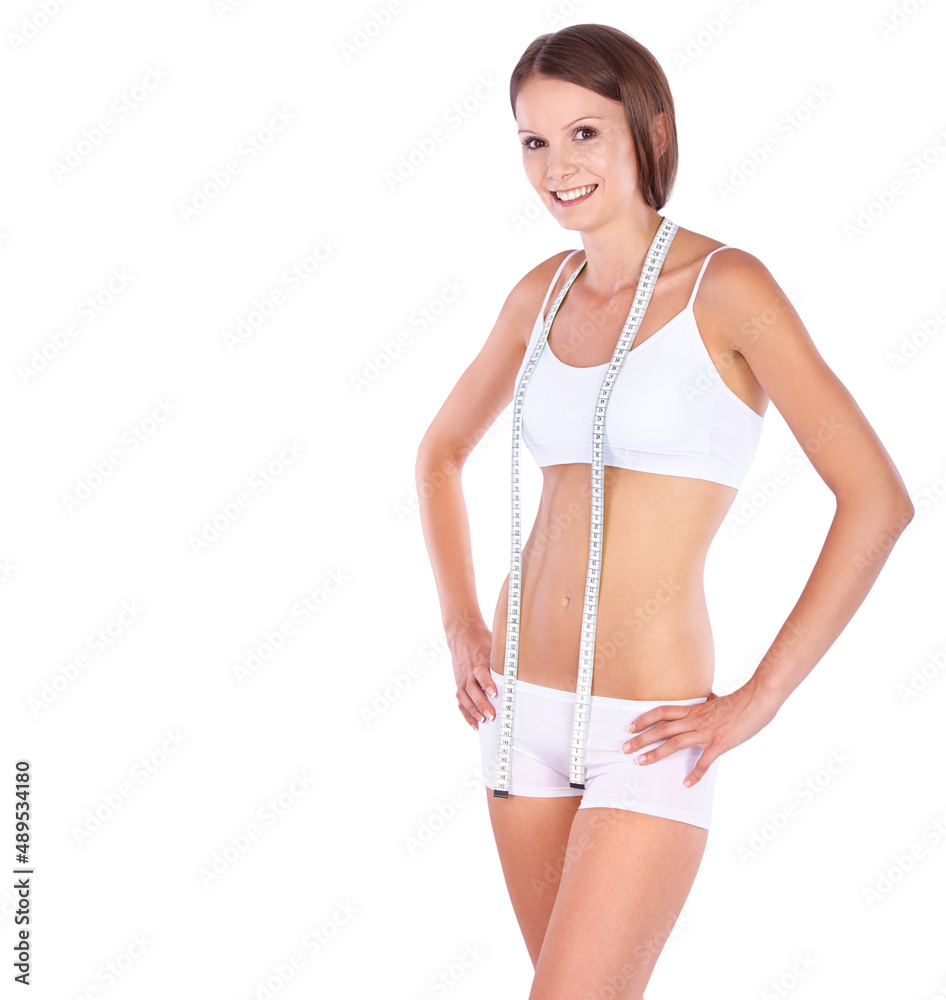 Shes tracking her fitness each day. Studio shot of a fit young woman with a measuring tape.