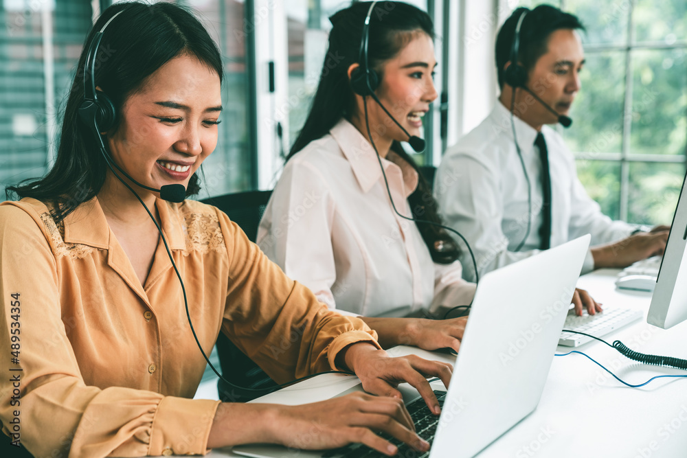 Business people wearing headset working actively in office . Call center, telemarketing, customer su