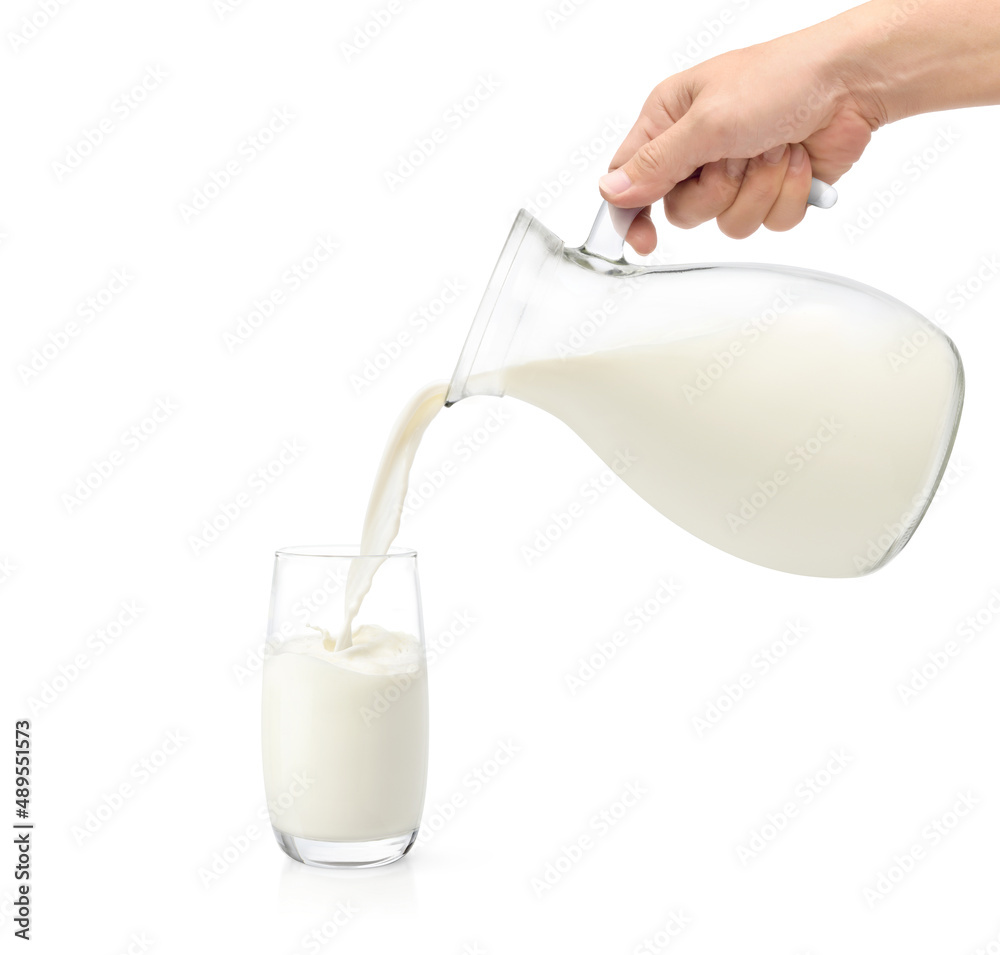 Pouring fresh milk into the glass isolated on white background.