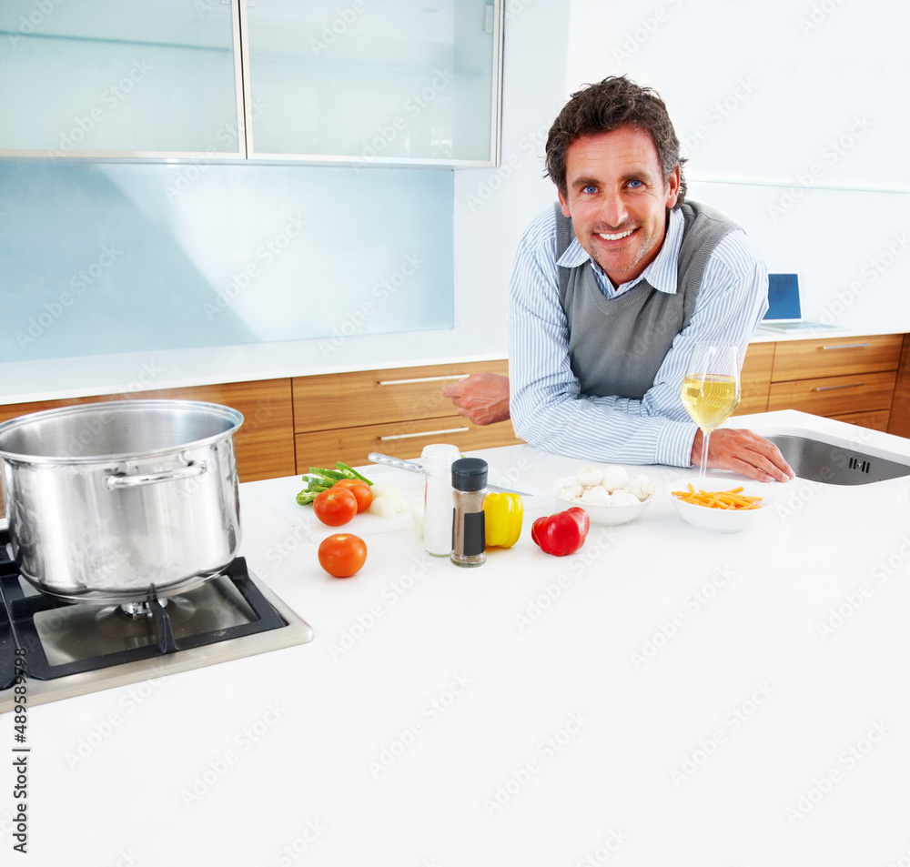 Handsome mature man standing in kitchen. Portrait of a handsome mature man standing in the kitchen.