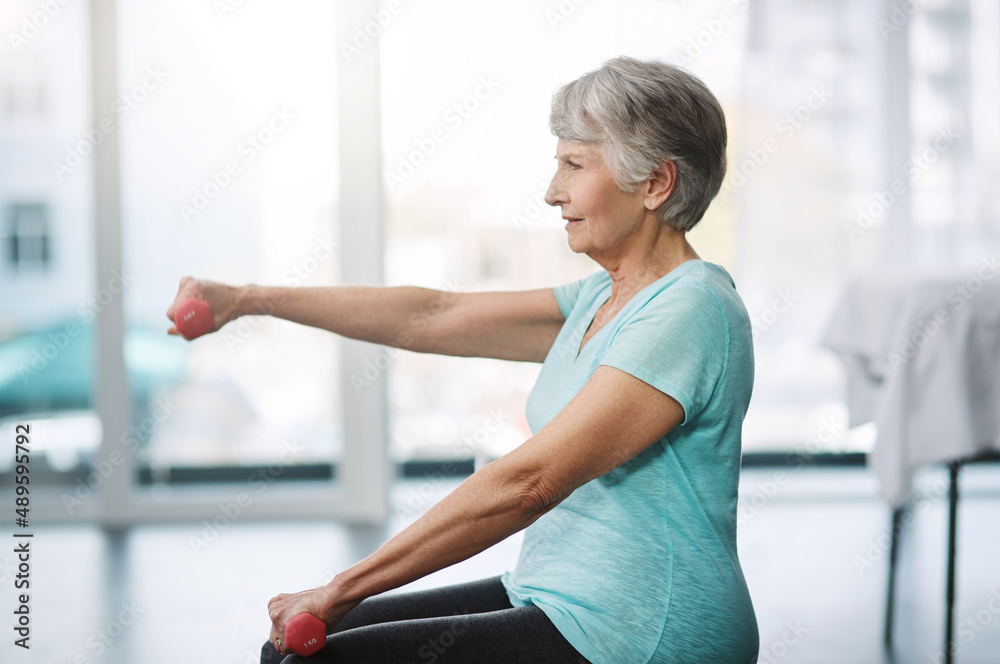 Working on keeping herself healthy. Cropped shot of a healthy senior woman working out with dumbbell