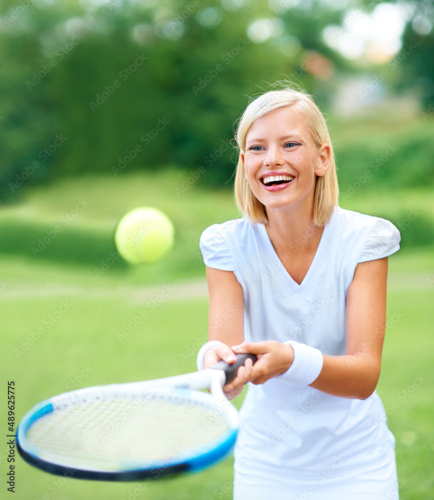 Just for fun. A young female tennis player bouncing the ball on her racquet for fun.