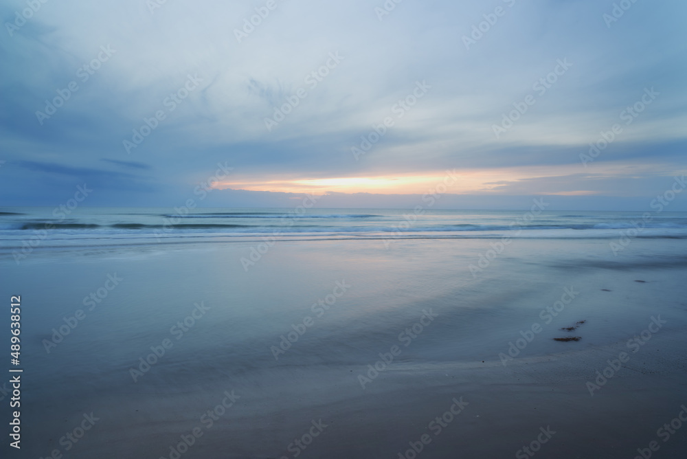 Remote natural beauty. A sunset over a desolate cloudy beach.