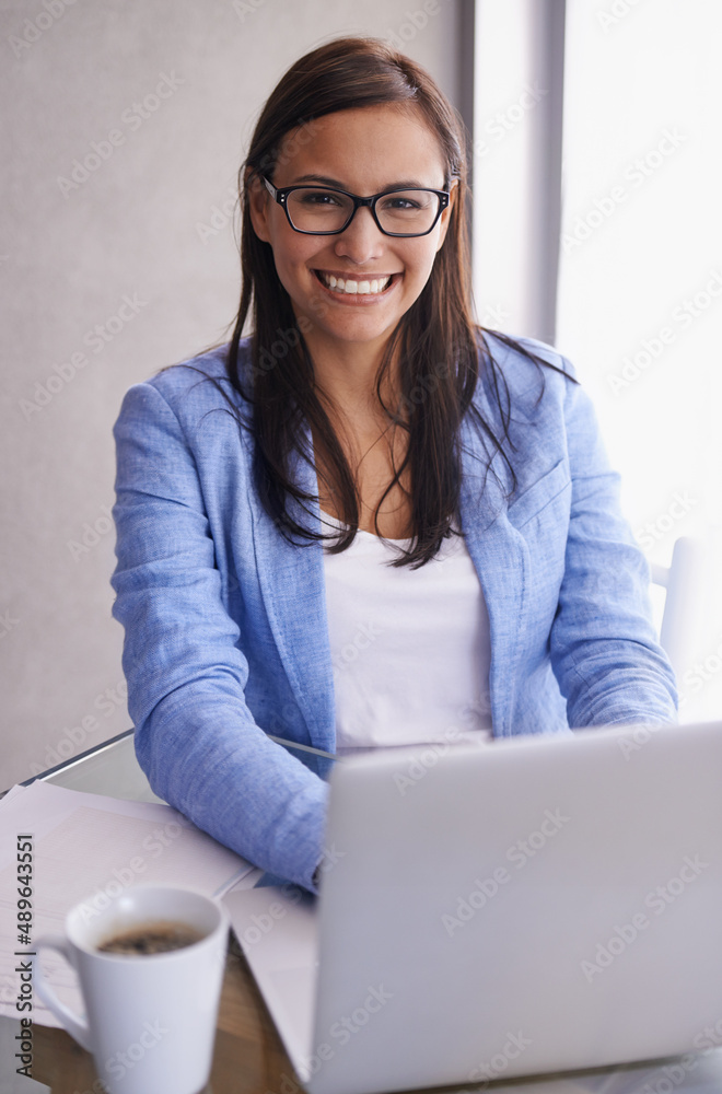 Having a productive day at the office. Portrait of an attractive young businesswoman using a laptop 