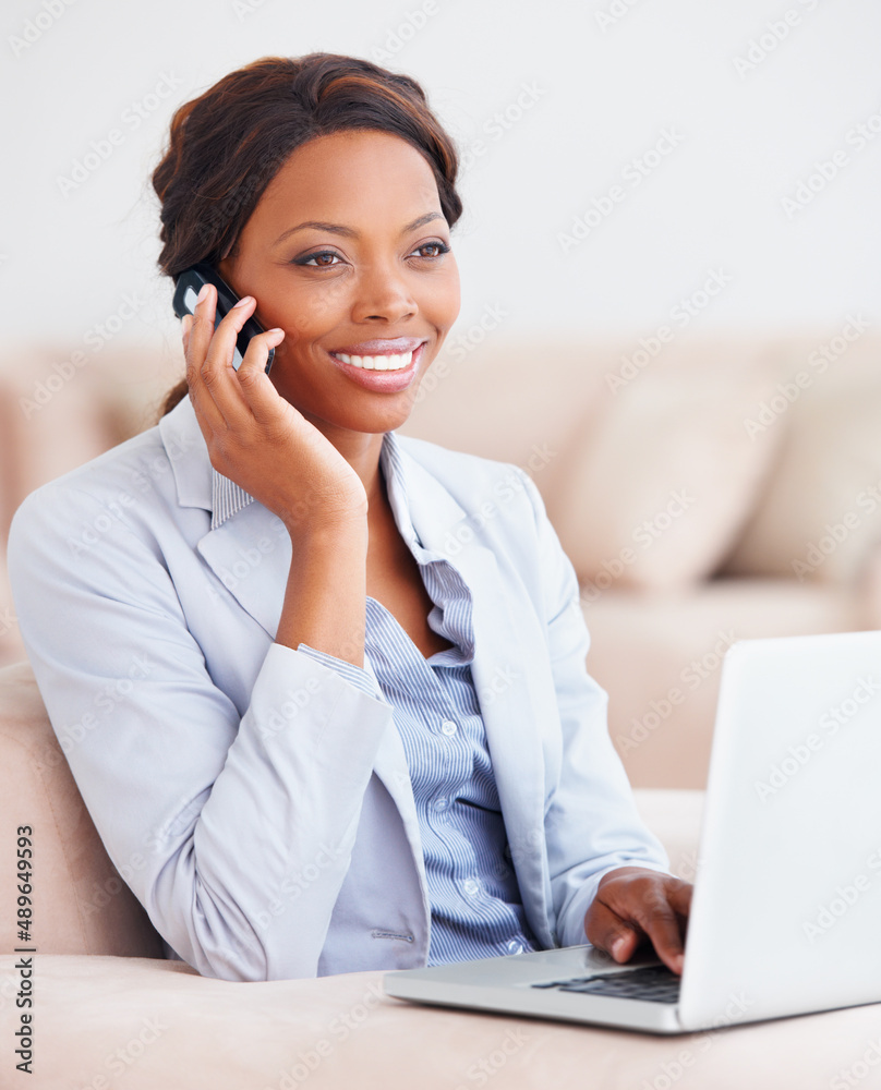 Connected from the comfort of home. A pretty young professional taking a call while working on her l